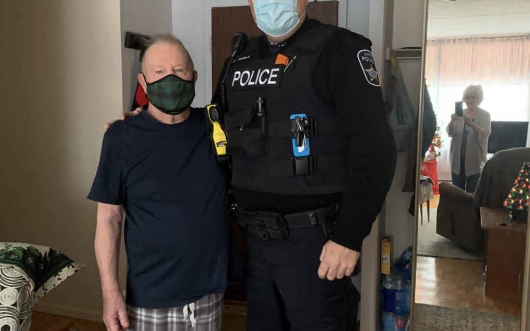 Sgt. John Parcells stands with the man whose life he saved in December 2020. Both are wearing masks due to COVID restrictions